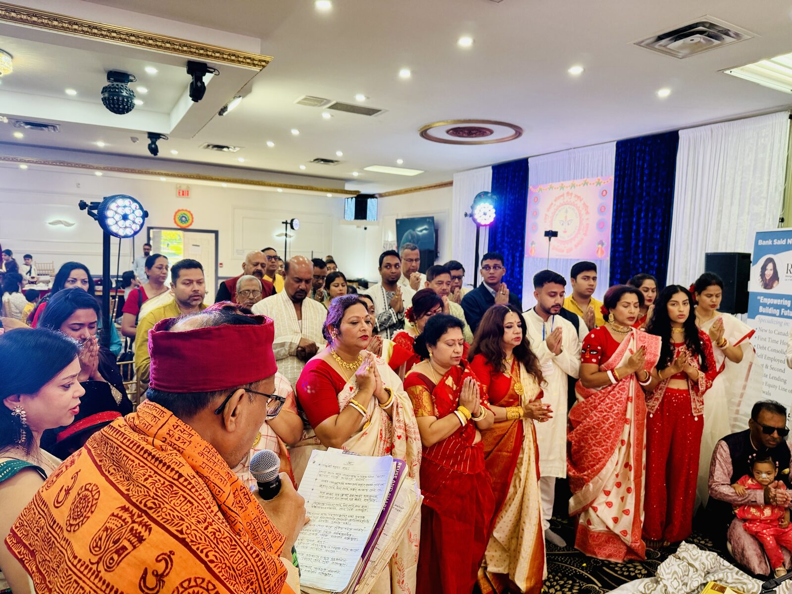 Community members offering pushpanjali together at TBCS Durga Puja